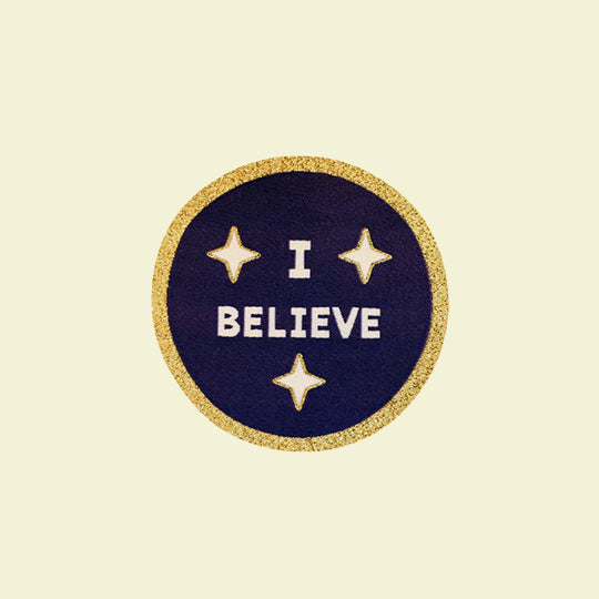 A festive patch featuring the words 'I Believe' perfect for adding holiday spirit to outfits and accessories.