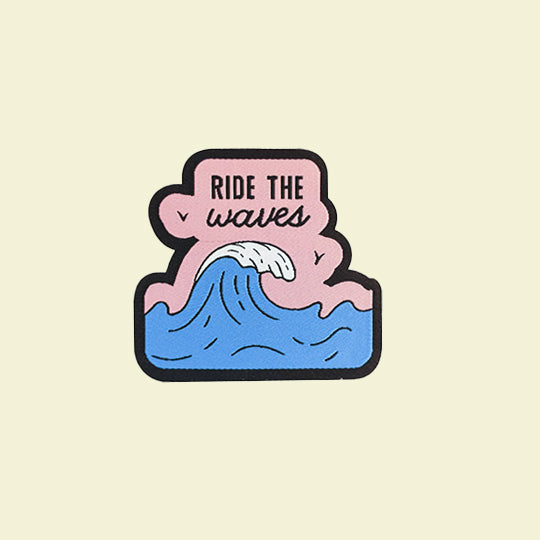 Patch design featuring the phrase 'Ride the Waves' with a vibrant wave illustration, perfect for surf enthusiasts.
