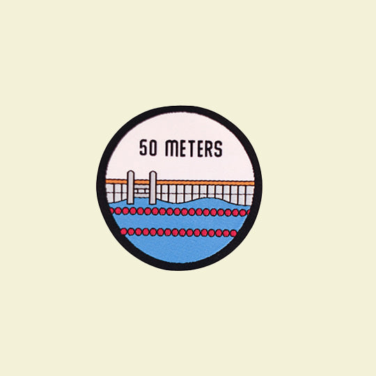 Swim patch indicating a 50-metre distance, commonly used to mark swimming achievements or distances in a pool.