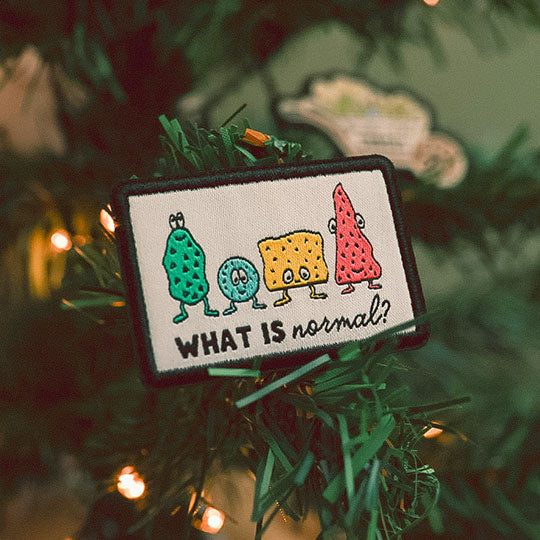 What is normal Iron-on patch attached in a Christmas tree, adding a decorative touch to the holiday decor.