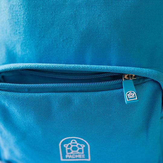 Canvas Blue kids backpack with the front small compartment open, showcasing colorful zipper, available at Pachee online store.