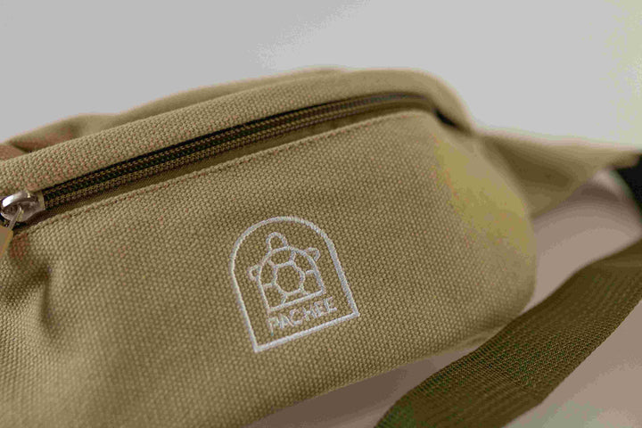 Close-up of Pachee Canvas Brown Bum Bag with front compartment closed and visible Pachee logo, showcasing quality craftsmanship.