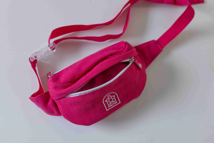 Front view of a Canvas Pink Bum Bag with the front compartment open, showcasing its stylish design and spacious interior.