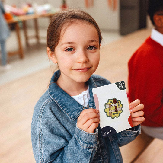 A girl displaying a "Connect with Kindness" patch, promoting positivity and kindness with a stylish design.