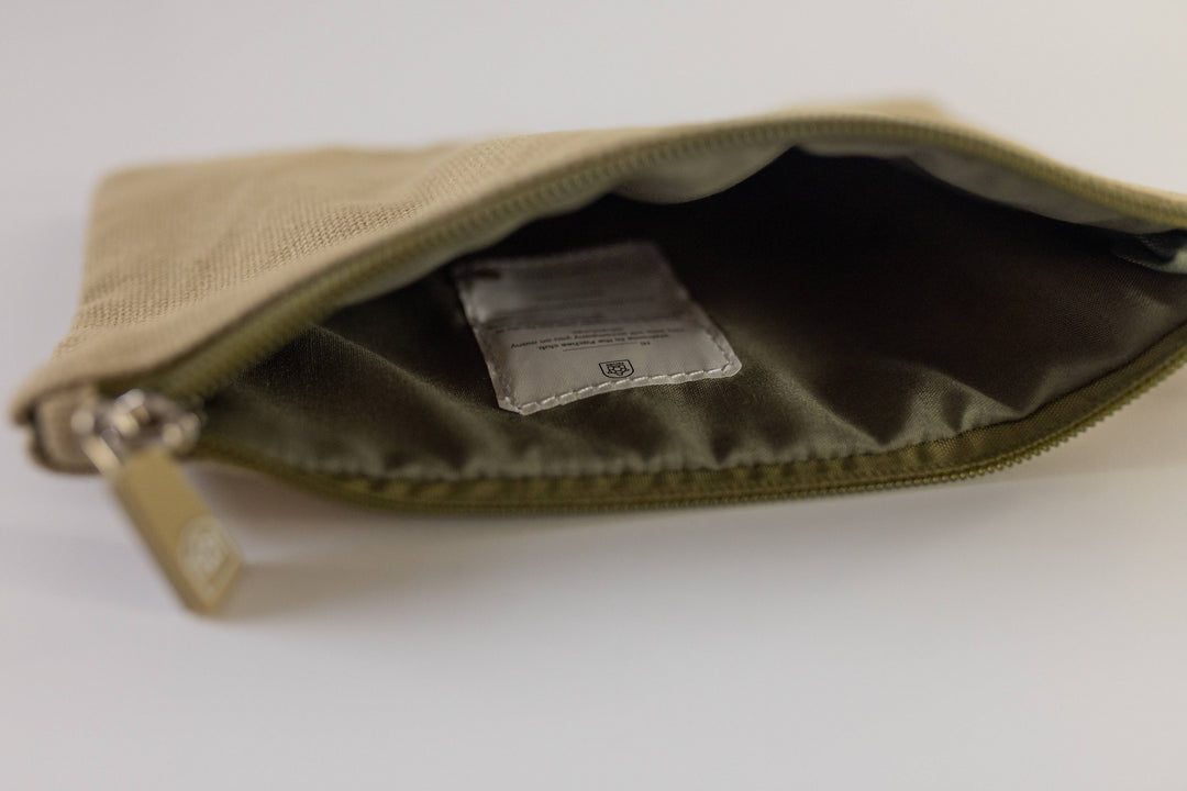 Neutral colour cotton zipper pouch opened to reveal its interior, perfect for storage and organisation. Available at Pachee in the UK.