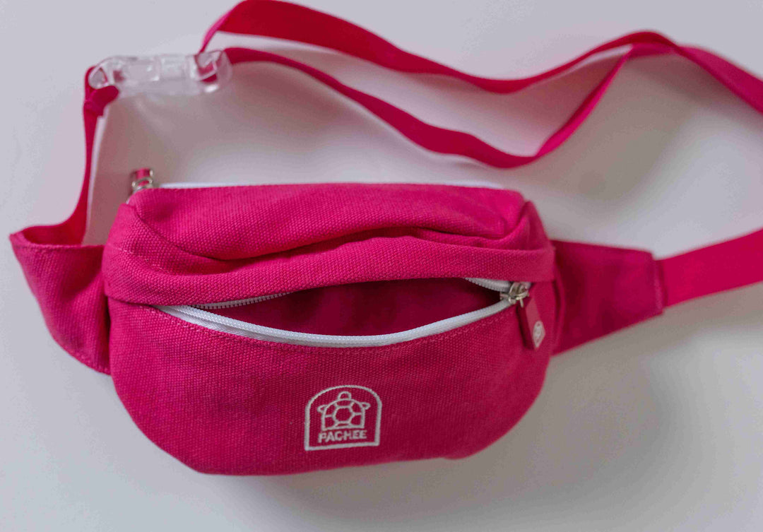 Front view of a pink crossbody kids bum bag from Pachee, featuring an open front compartment, showcasing its design.