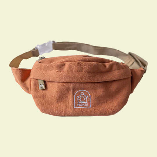 A cross-body orange bum bag featuring the Pachee logo, showcasing its stylish and functional design. Available at Pachee online store.