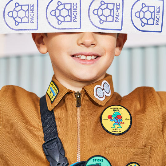 Boy wearing a jacket with Crouching Tiger Little Dragon patch and My Glasses patch, showcasing a unique, stylish design.