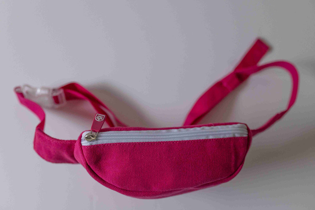 Kids pink bum bag from Pachee with a secure closed zipper on the back, perfect for carrying essentials while on the go.