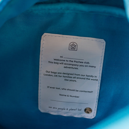 Kids Pre-school Backpack in an open view, showcasing inner label for child's name and contact number details with Pachee welcome note.
