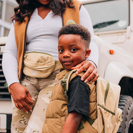 Boy wearing a neutral color mini backpack, perfect for preschool. Available at Pachee online store.