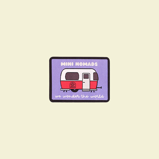 Mini-nomad Campervan Patch featuring the phrase "With Mini-nomads we wander the world" and a red camper van.