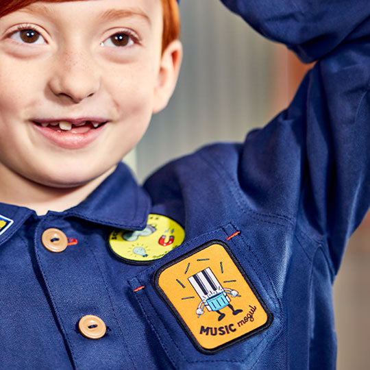 Boy wearing a shirt with a Music Mogul patch attached, showcasing a stylish and unique clothing design.
