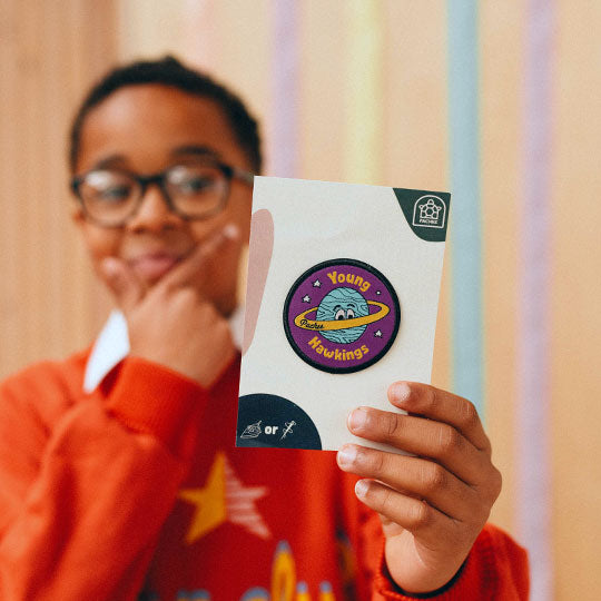 A boy displaying the Young Hawkings Patch from Pachee.