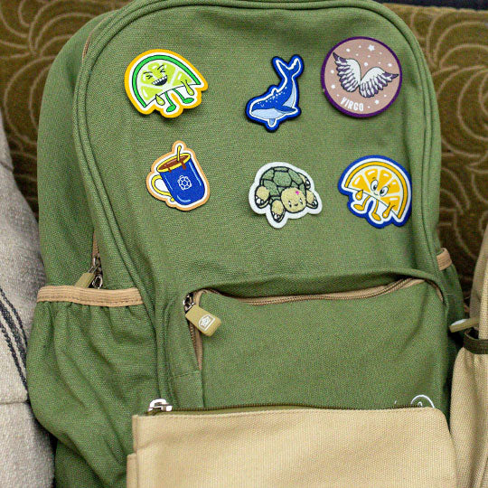 Sage Green backpack with unique patches like Lemon and Lime patch, Blue Whale patch, Virgo Zodiac sign patch, and Tortoise Patch.