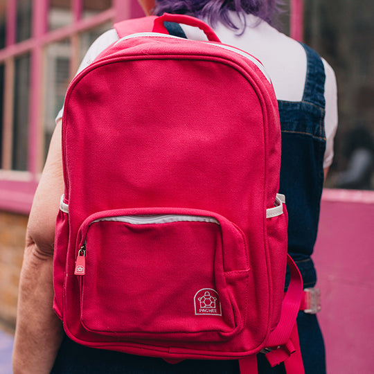 A young girl wearing a personalised pink backpack on her shoulder, perfect for children, with a stylish and fun design.