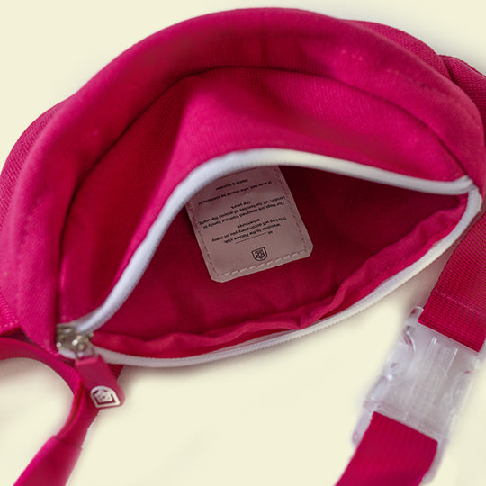 Pink kids bum bag from Pachee, open to display spacious interior and welcome label tag with Name & contact information space.