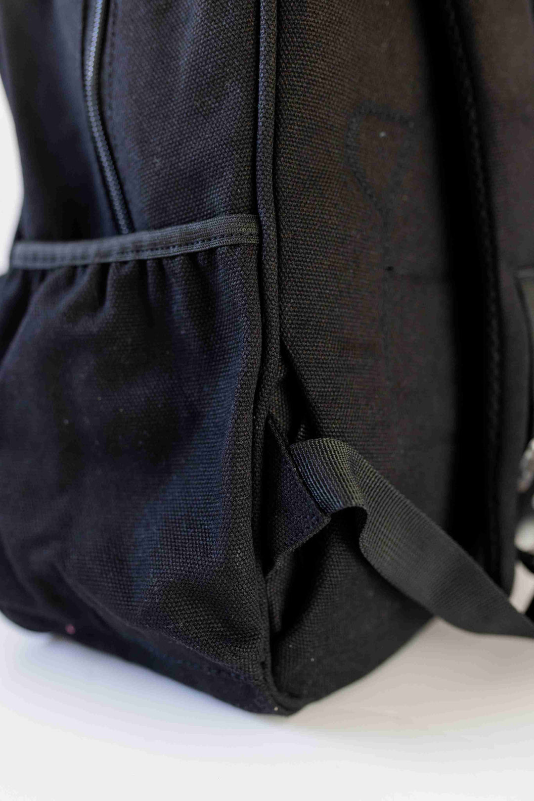 Quality Junior black backpack featuring a bottle holder, highlighting its stylish design, available at Pachee online store.