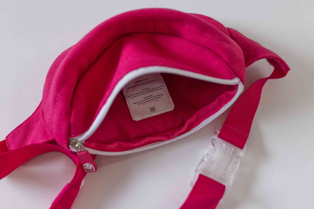 Pink kids' bum bag from Pachee, open to display spacious interior, highlighting high-quality design and functionality.