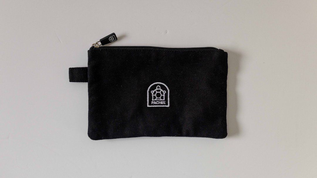 Small black pouches with a side holder and zipper, available for purchase at Pachee's online store in the UK.