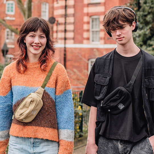 Unisex crossbody bum bags: a boy wearing a sleek black bum bag and a girl sporting a neutral-toned bum bag, stylish and practical.