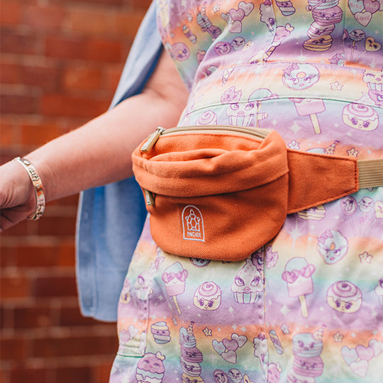 Woman wearing an orange waist bum bag, styled for comfort and practicality, perfect for hands-free convenience and fashion.