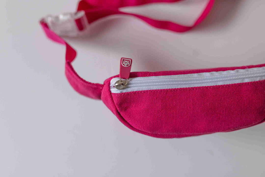 Kids crossbody bum bag with a white zipper, perfect for carrying small essentials. Available in bright colors at Pachee online store.