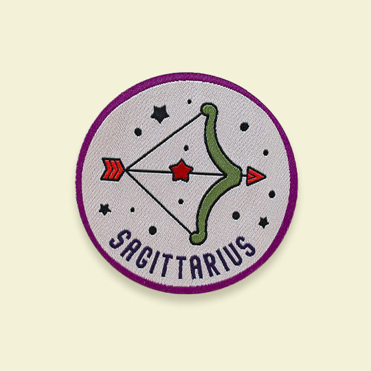 Zodiac Sagittarius patch featuring a bold archer symbol with 'Sagittarius' text, available as iron-on or sew-on for easy application.