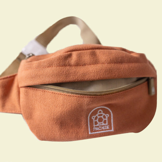 Kids Canvas orange crossbody bum bag with an opened front compartment, showcasing stylish design. Available at Pachee.