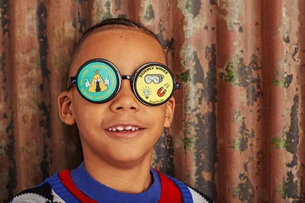Boy wearing glasses, with "Cool Camper" on one side and "Science Whizz" on the other side.