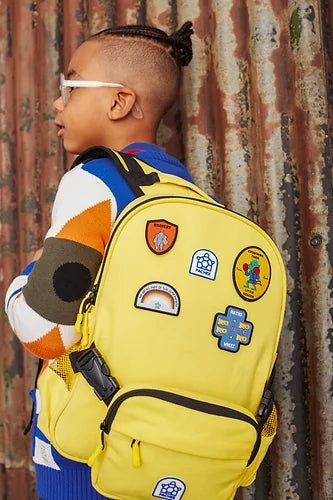 Boy wearing a belt backpack adorned with personalised patches, showcasing a fun and customised accessory for everyday use.